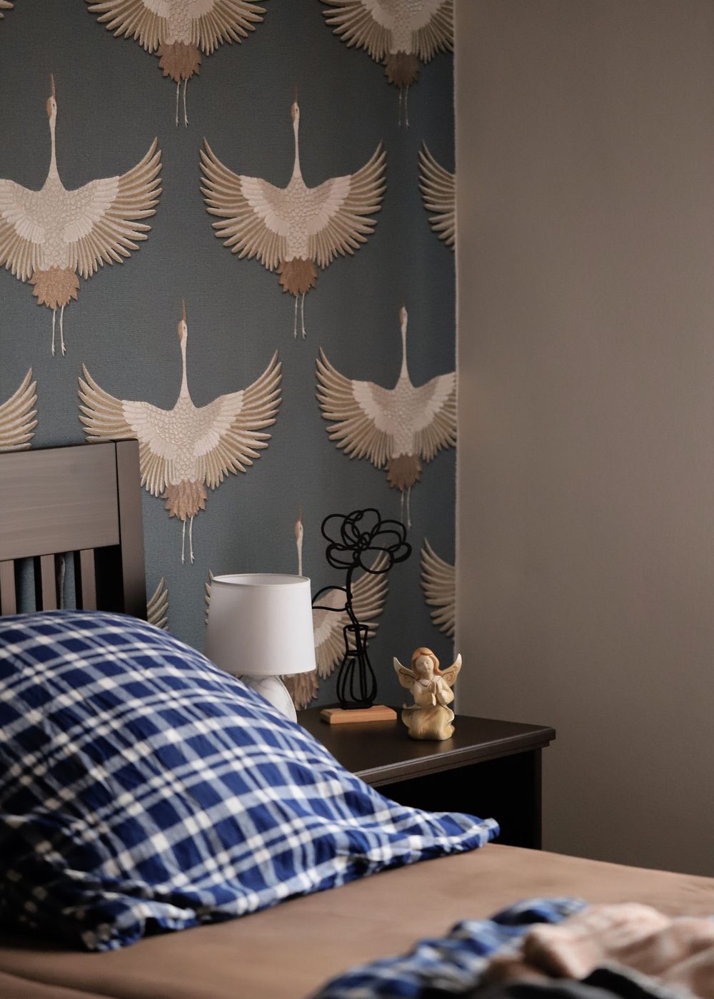 Bedroom accent wall in slate-blue crane-bird chinoiserie wallpaper